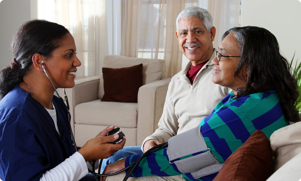 Nurse checking blood pressure of couple